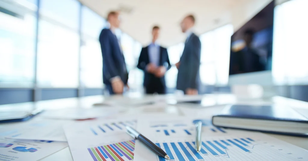 People in a meeting and some graphics on the table